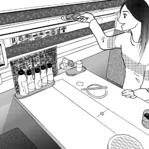 Woman sitting in a box seat at a conveyor-belt sushi restaurant